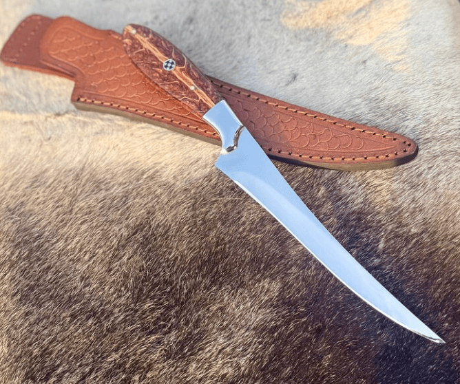 custom handmade fillet/hunting knife with a long, narrow and curved blade used for skinning or filleting with genuine leather sheath